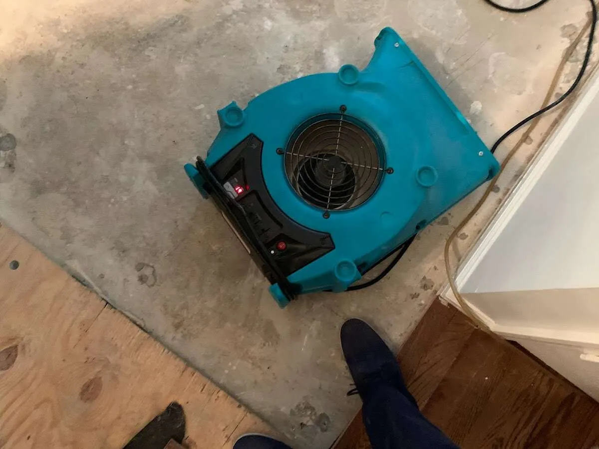 Air mover drying subfloor during Leak Detection & Repair in Ozark